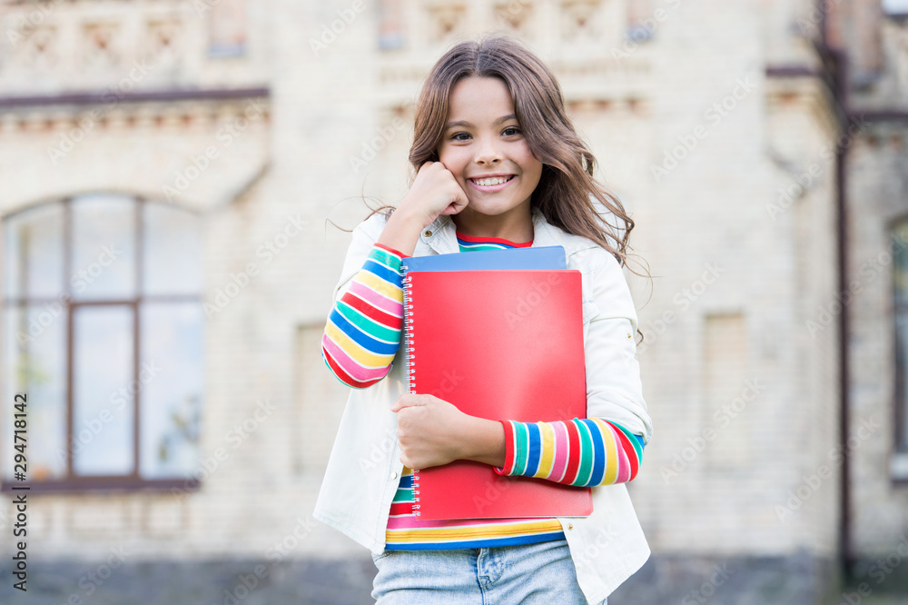 Kid smiling girl school student hold workbooks textbooks for studying. Education for gifted children. Successful pupil. Taking extra course for deeper learning. School education. Modern education