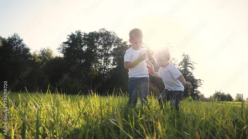 Happy family: funny slow motion video little kid boy hold hands play whirl a and girl brother sister hold hand on nature happy children concept. children happy family boy girl slow lifestyle motion Happy family: funny slow motion video little kid boy hold hands play whirl a and girl brother sister hold hand on nature happy children concept. children happy family boy girl slow lifestyle motion