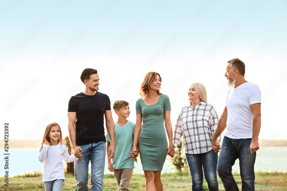 Big family resting together in park