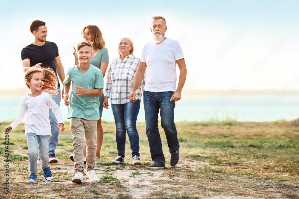 Big family resting together in park