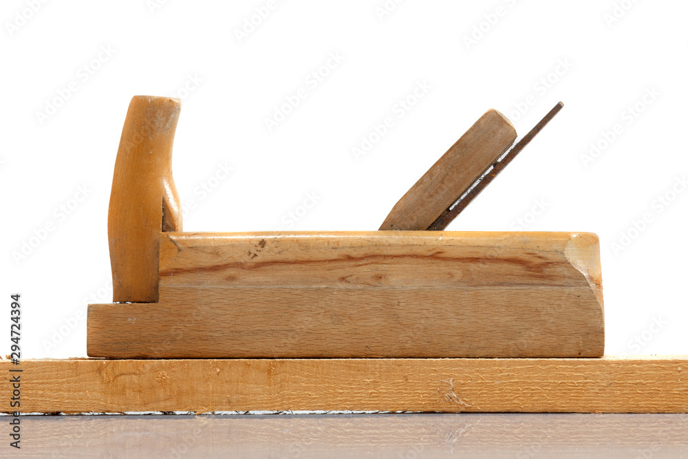 Old wooden hand planer or Carpenter Tool on wood plank isolated white background Old wooden hand planer or Carpenter Tool on wood plank isolated white background
