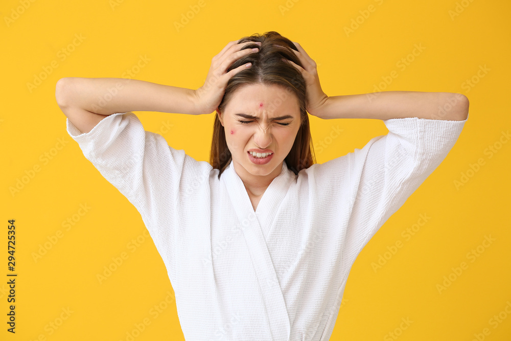 Portrait of stressed young woman with acne problem on color background Portrait of stressed young woman with acne problem on color background