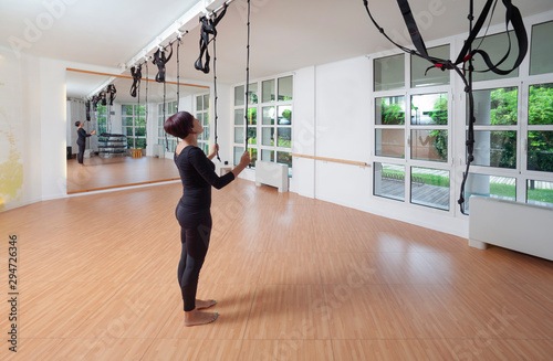 Saronno-Italy 15 Settembre 2019- una donna controlla le corde prima di eseguire un esercizio di pilates in palestra photo