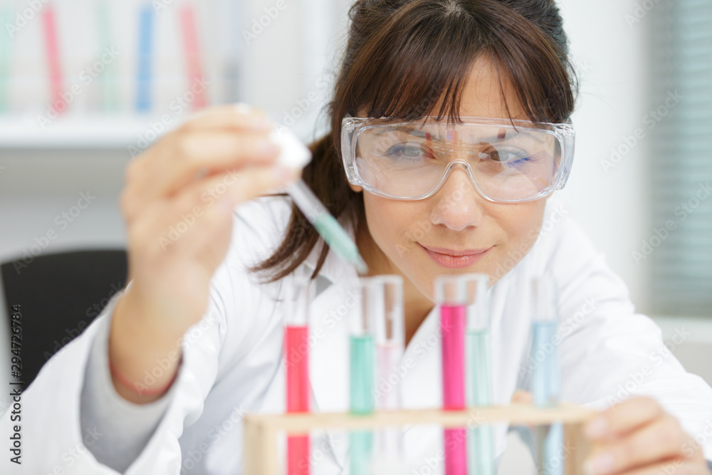 a biologist chemist woman doing laboratory experiments a biologist chemist woman doing laboratory experiments