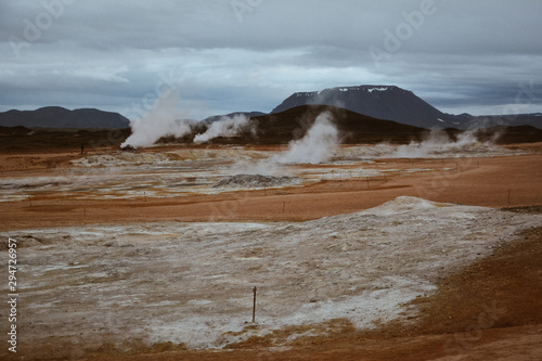 Boiling mudpots in the geothermal area Hverir and cracked ground around, Iceland in summer. Myvatn region, North part of Iceland photo