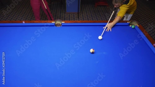 couple, man and bald woman play american billiards. photo