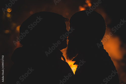 Silhouette of romantic hipster couple photo