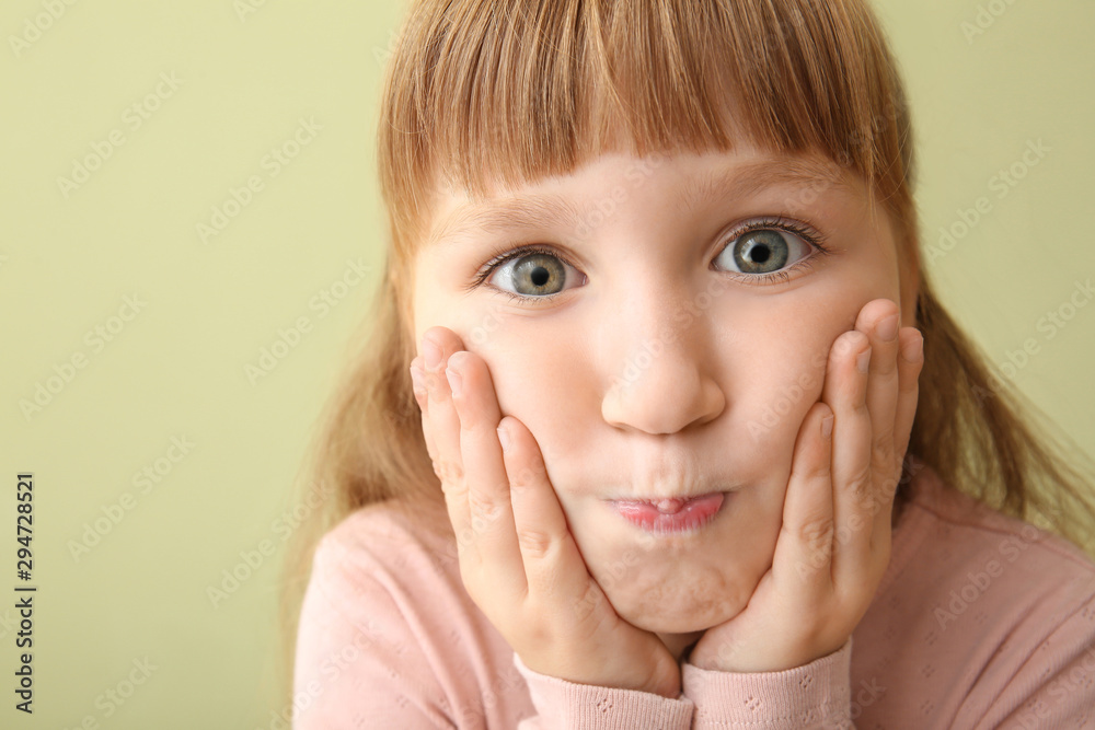 Grimacing little girl on color background, closeup Grimacing little girl on color background, closeup