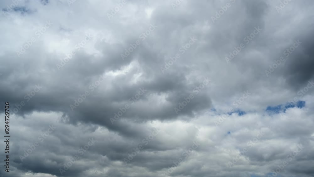 Time lapse of dark clouds running through the blue sky