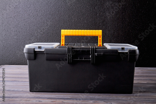 Close up tool box on dark background. Black case with tools and instruments. Repair tool kit. photo