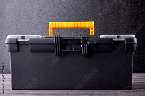 Tool box close up. Black and yellow hand tool case. Repair and construction concept. photo