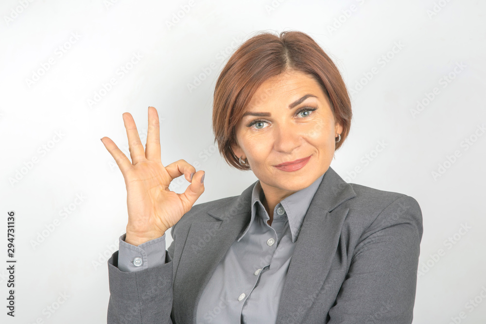 Business woman in suit shows ok sign with hands Business woman in suit shows ok sign with hands