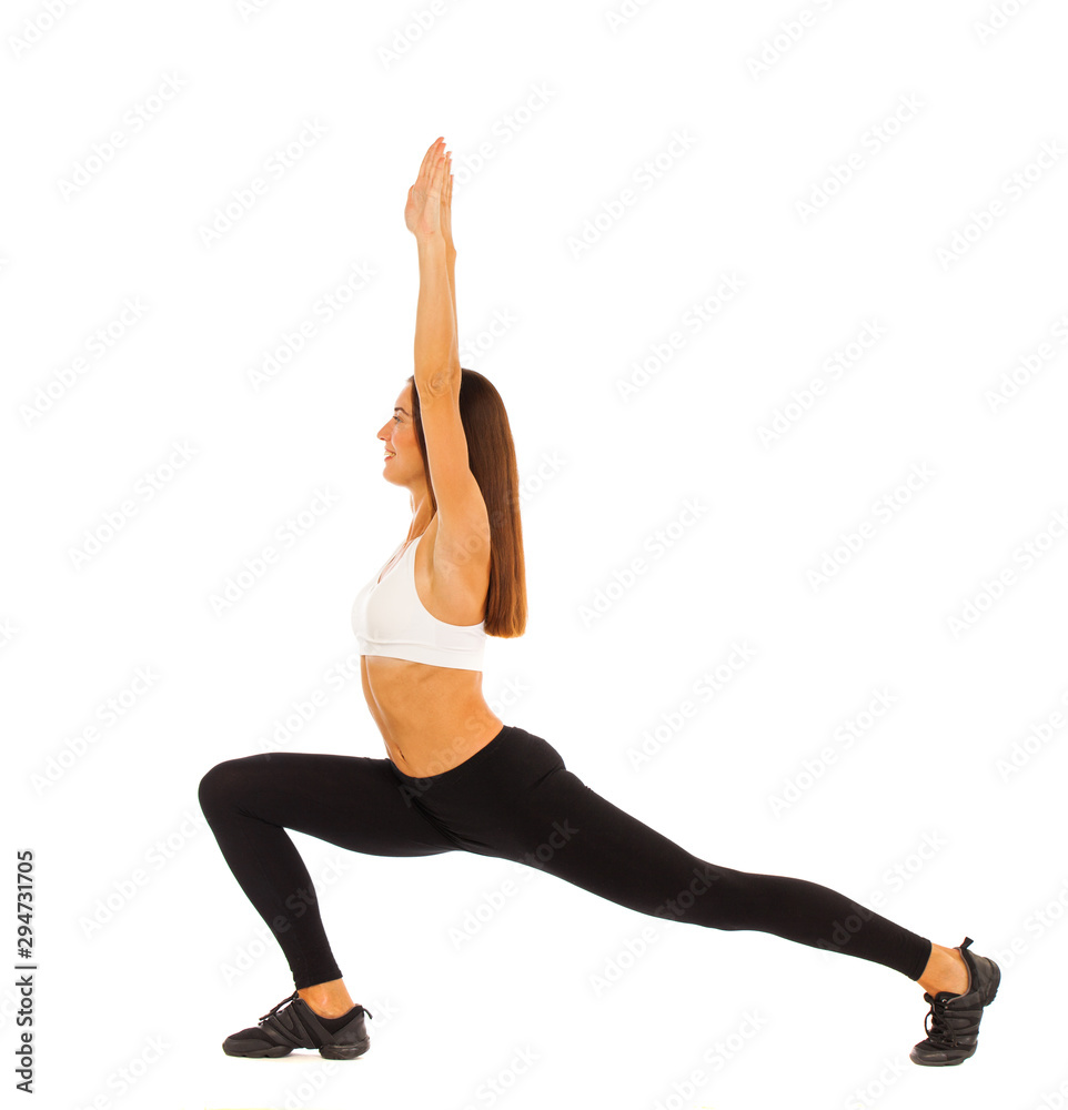 Sexy fitness woman posing in studio - isolated on a white background