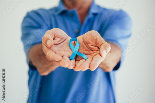 Prostate Cancer Awareness. Man with light Blue Ribbon for supporting people living and illness. Men Healthcare and World cancer day concept photo
