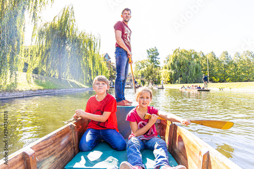 Father with children on family punting in Cambridge