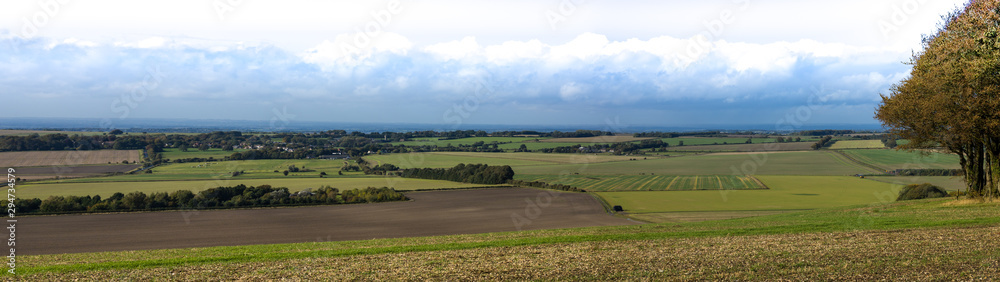 Panoramic landscape from Hackpen hill Wiltshire. Arable farmland spreads before.