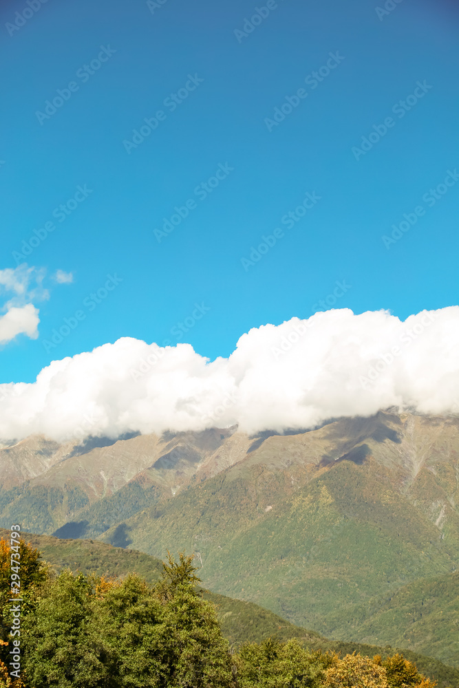 Fototapeta premium autumn sky with clouds, landscape of mountains and waterfall
