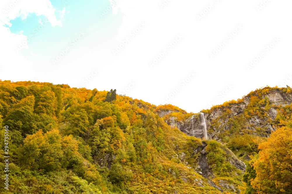 autumn sky with clouds, landscape of mountains and waterfall