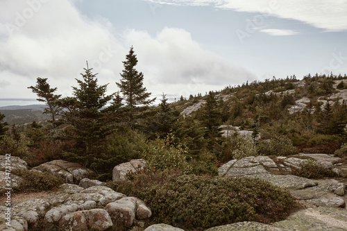 Hiking along granite bedrock on the summit of Cadillac Mountain in Acadia National Park on Mount Desert Island, Maine.