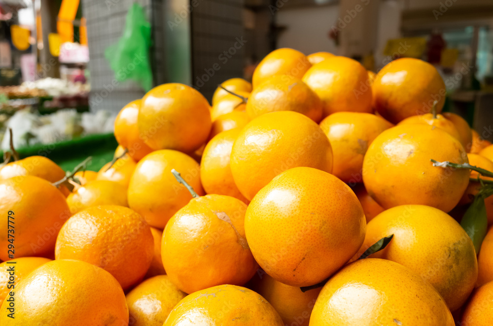 orange fruit stacked on the marketplace