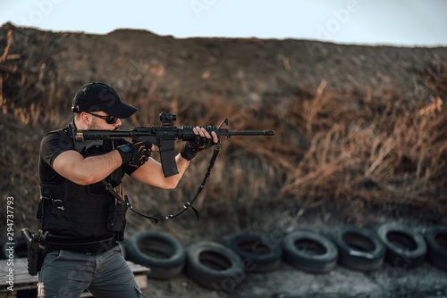 Special force member shooting with sniper rifle.