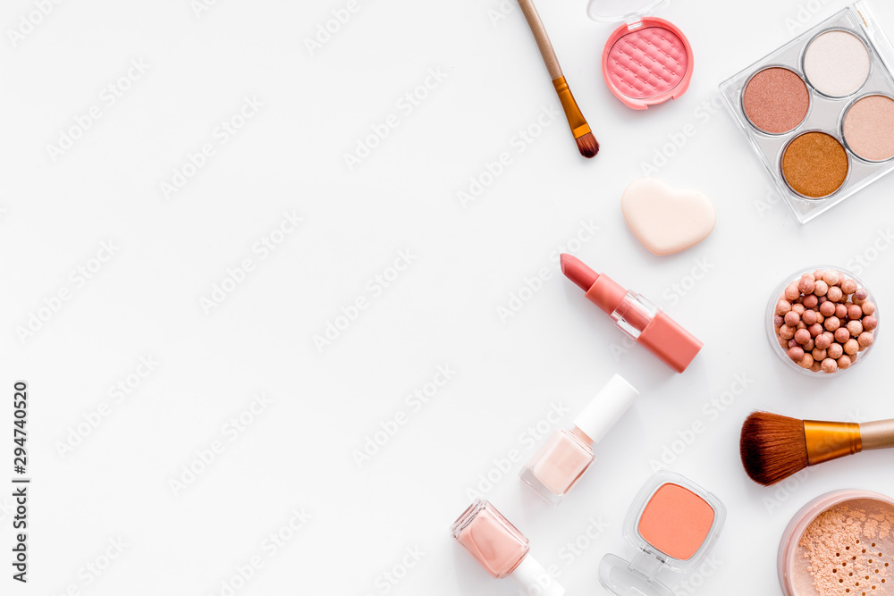 Makeup concept. Frame with decorative cosmetics and brushes on white background top view copy space Makeup concept. Frame with decorative cosmetics and brushes on white background top view copy space