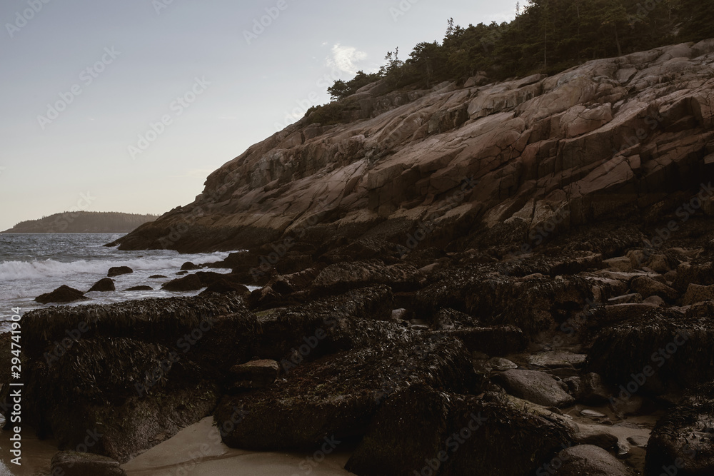 Sunset over rugged coastline of Sand Beach on a cool Fall evening in Acadia National Park on Mount Desert Island, Maine.