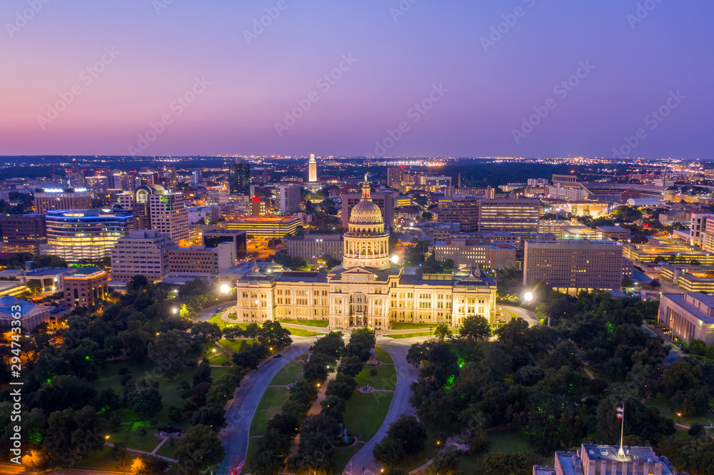 Aerial photo of the Texas State Capitol Building illuminated at Dusk in Downtown Austin with the University of Texas in the background   | Drone Photo