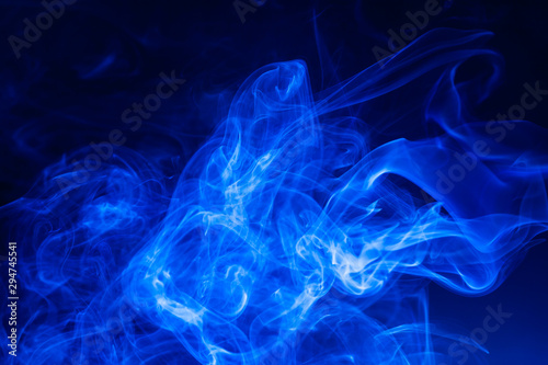 Blue smoke on black background. © peterkai