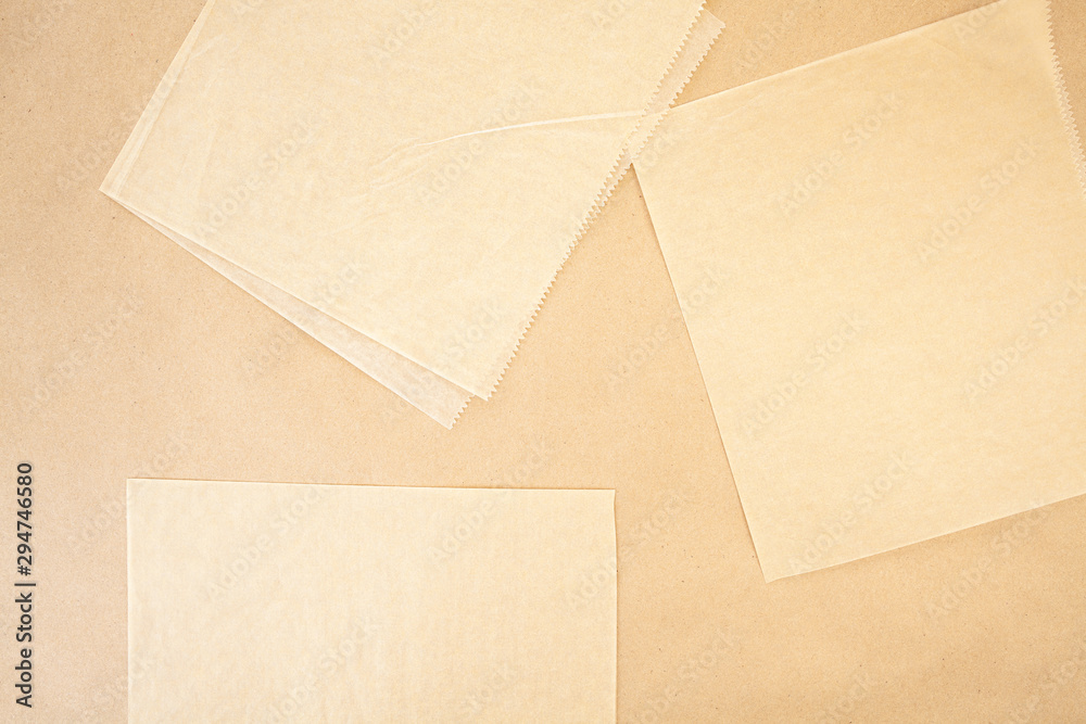 Layers of parchment and and craft paper background texture with serrated edges in beige and tan colours Layers of parchment and and craft paper background texture with serrated edges in beige and tan colours