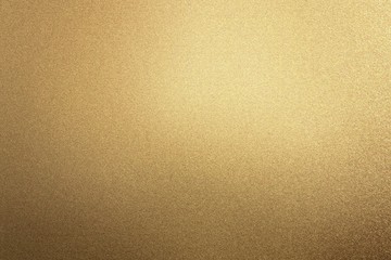 Glowing rough bronze metal board wall, abstract texture background