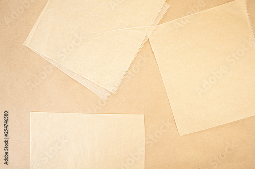 Layers of parchment and and craft paper background texture with serrated edges in beige and tan colours