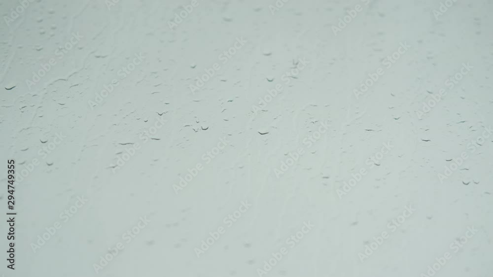 Video of wet window. Raindrops on wet glass against a gray sky. Video of wet window. Raindrops on wet glass against a gray sky.