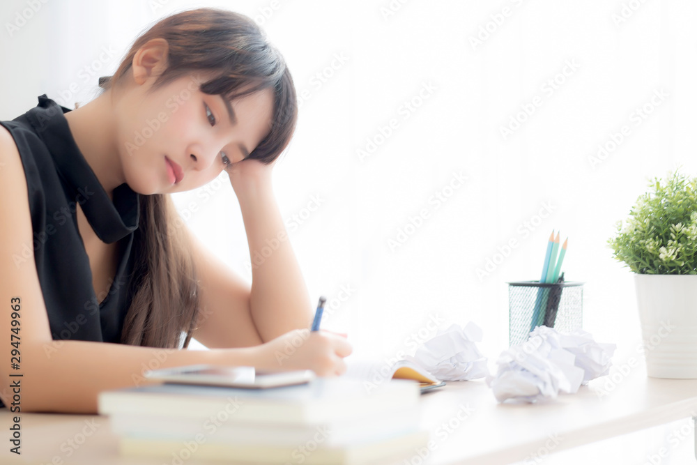 Beautiful asian woman tired and stressed with writing overworked at desk, girl with worried not idea with notebook and crumpled paper at office, freelance and business concept. Beautiful asian woman tired and stressed with writing overworked at desk, girl with worried not idea with notebook and crumpled paper at office, freelance and business concept.