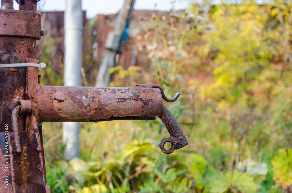 an old iron water tap on the street. an old iron water tap on the street.