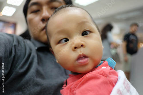 Asian boy with strabismus and dad.