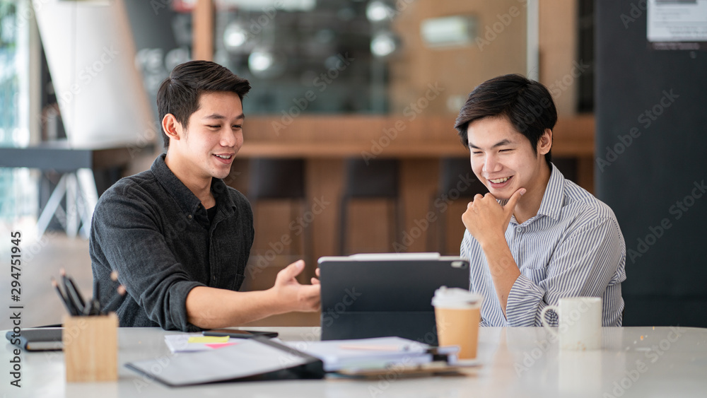 Young business colleagues talking with digital tablet in modern office. Young business colleagues talking with digital tablet in modern office.