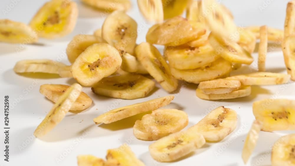 Banana Chips falling onto a white surface in slow motion