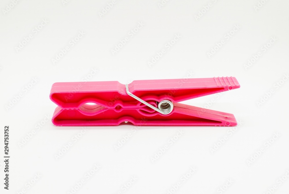 A red clothes peg isolated on white background.