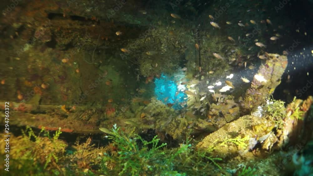 Wreck inside underwater in Truk Lagoon on Chuuk Islands. Shipwreck in historic place of terrible tragedy of WW II and diver among wreckage of ship. Wreck inside underwater in Truk Lagoon on Chuuk Islands. Shipwreck in historic place of terrible tragedy of WW II and diver among wreckage of ship.