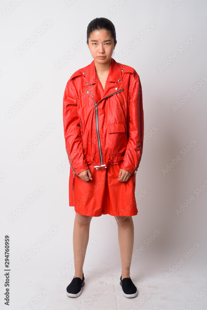 Full body shot of young Asian rebellious woman looking serious Full body shot of young Asian rebellious woman looking serious