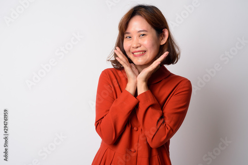 Portrait of happy beautiful Asian woman smiling and posing