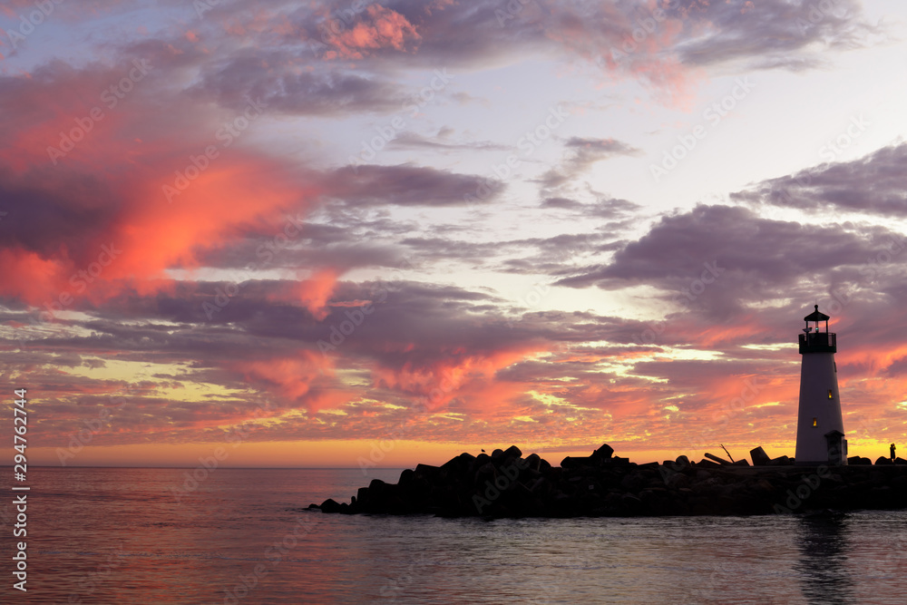 Vibrant dusk over Breakwater (Walton) Lighthouse as seen from Seabright Beach. Santa Cruz, California, USA.