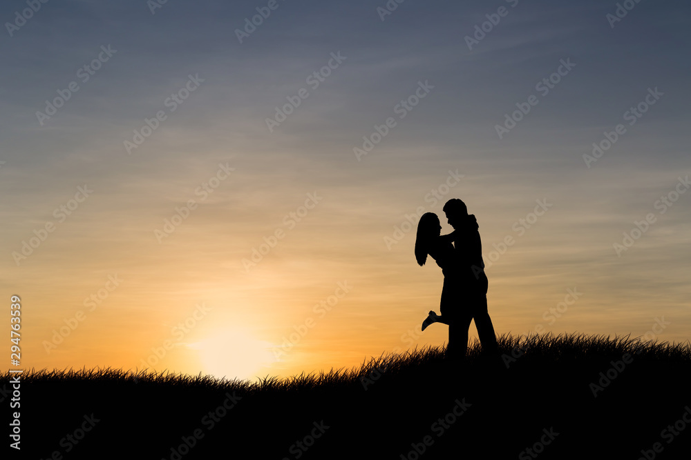 Fototapeta premium Silhouettes of couple man and woman in nature sunset background. Love concept.