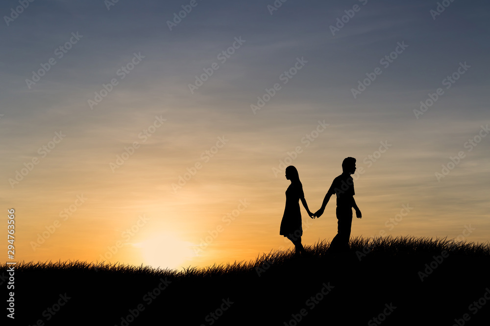 Silhouettes of couple man and woman broken heart at nature sunset. Love concept. Silhouettes of couple man and woman broken heart at nature sunset. Love concept.