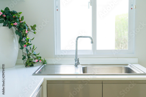 Modern white kitchen with counter and white details  minimalist interior  Full set of kitchen equipment