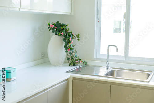 Modern white kitchen with counter and white details  minimalist interior  Full set of kitchen equipment