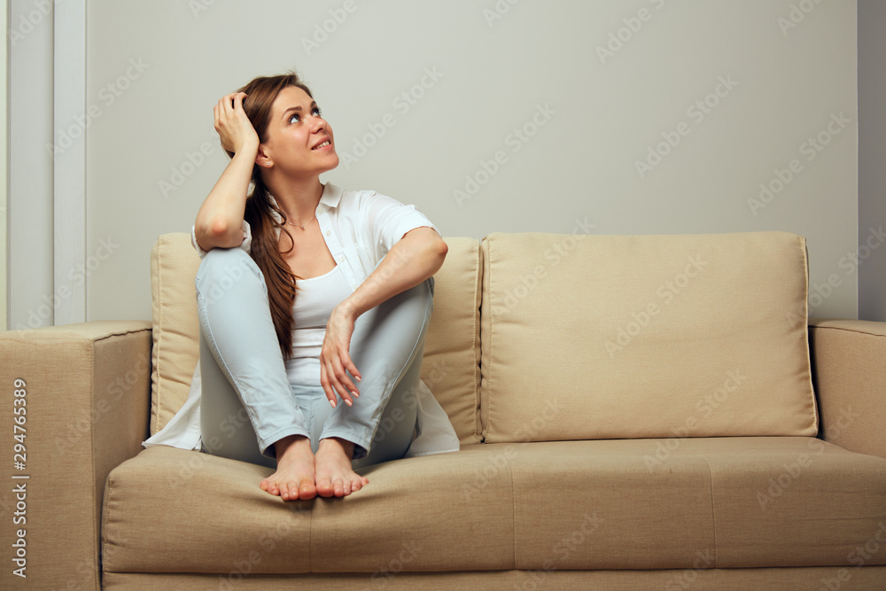 Woman rest on sofa and looking up. Woman rest on sofa and looking up.