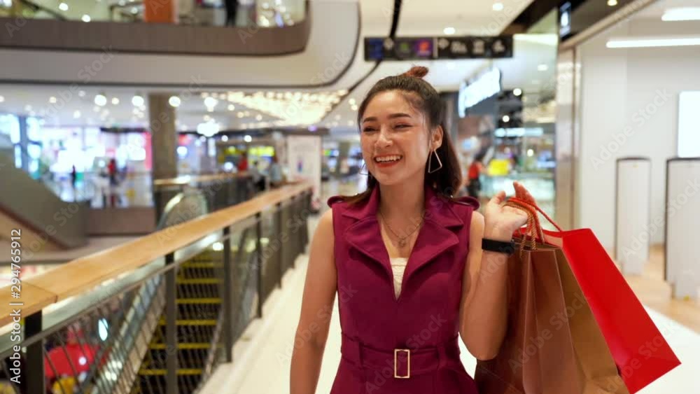 slow-motion of young woman walking with shopping bags in the mall slow-motion of young woman walking with shopping bags in the mall