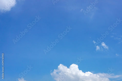 A bright blue sky with some white clouds